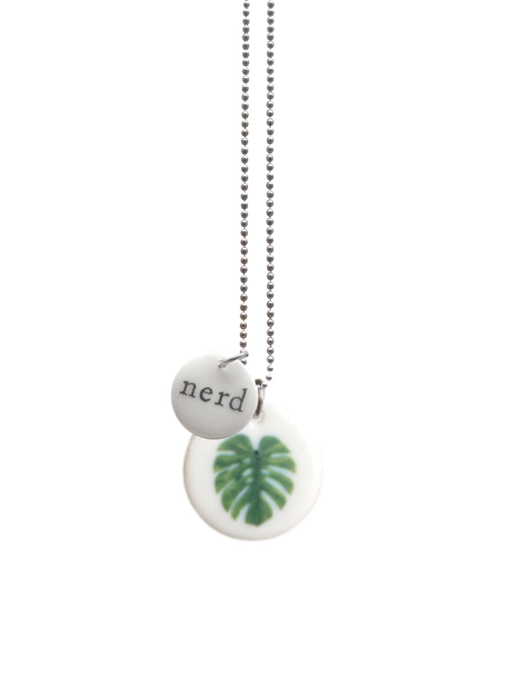 Handgemaakte keramieken hanger medium met monstera blad en kleine hanger met de tekst Nerd aan ketting