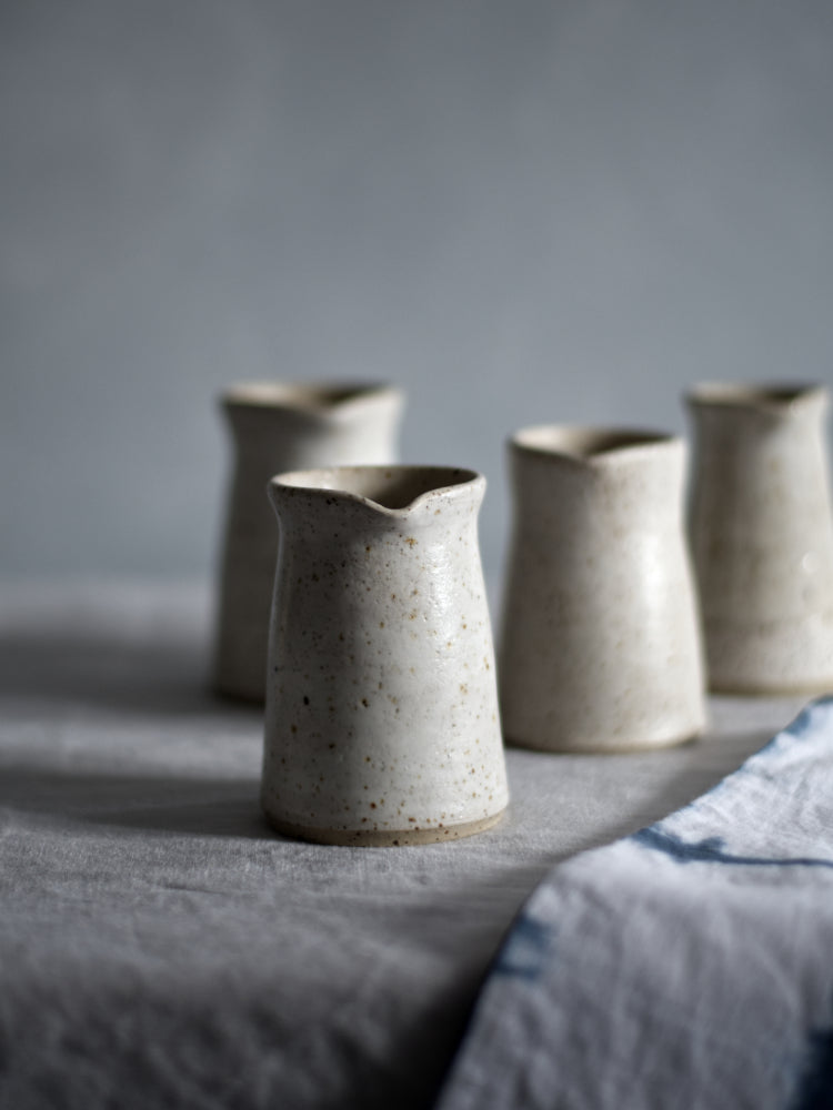 Schenkkannetjes op een rij, achtergrond is vaag, close up